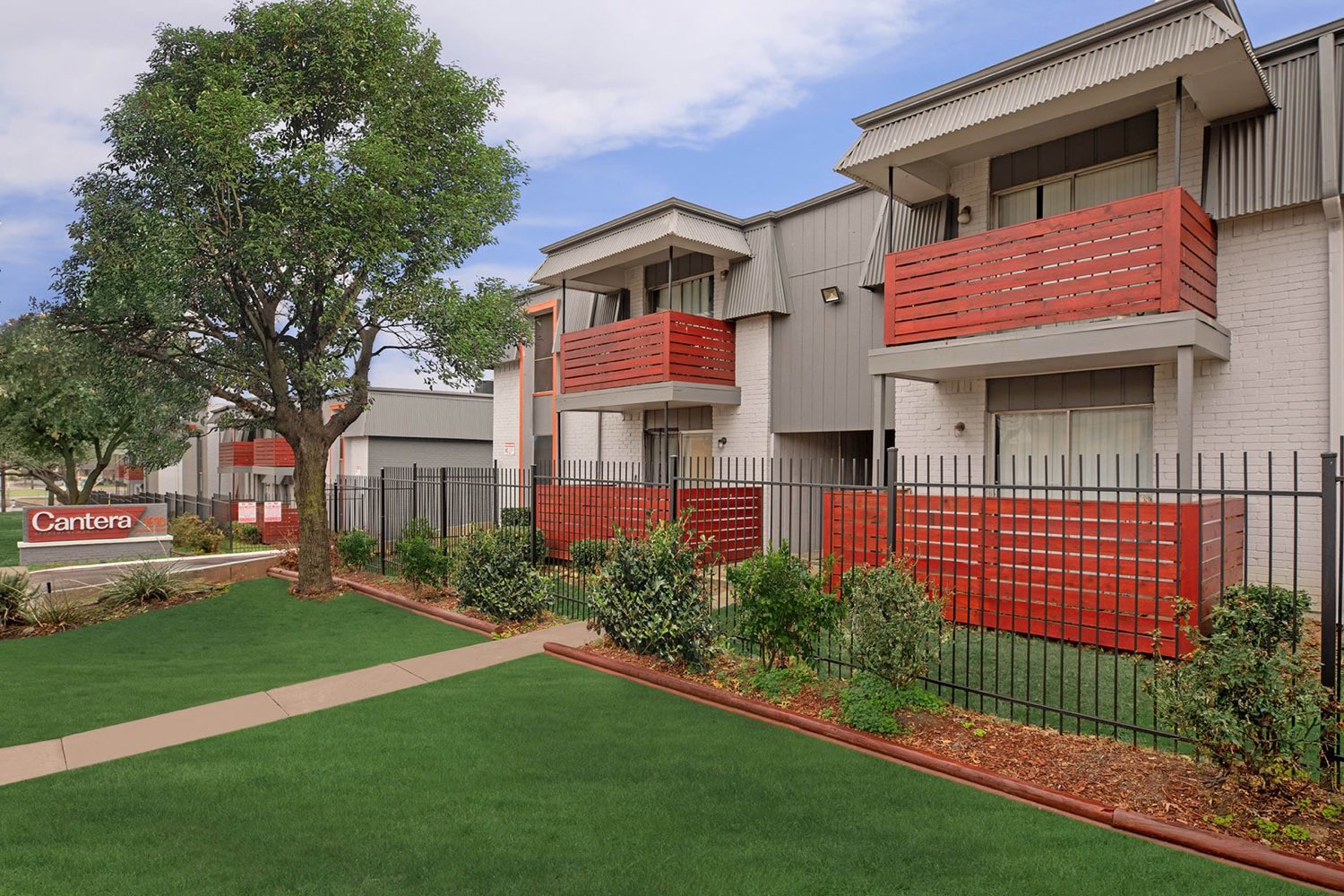 Cantera Apartment Homes exterior with red balconies